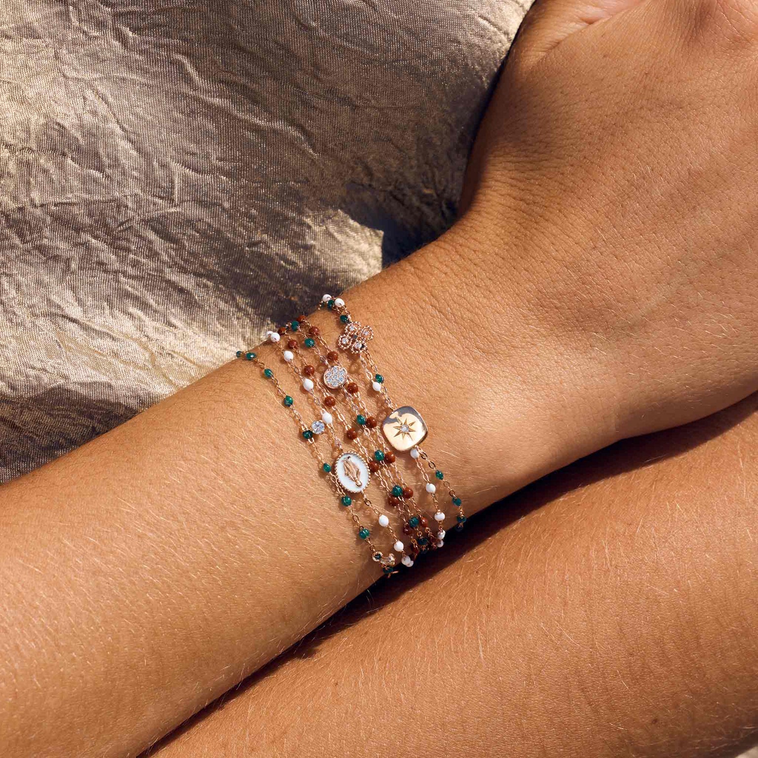 Photo d’un poignet portant plusieurs bracelets de différentes couleurs et modèles Gigi Clozeau. 