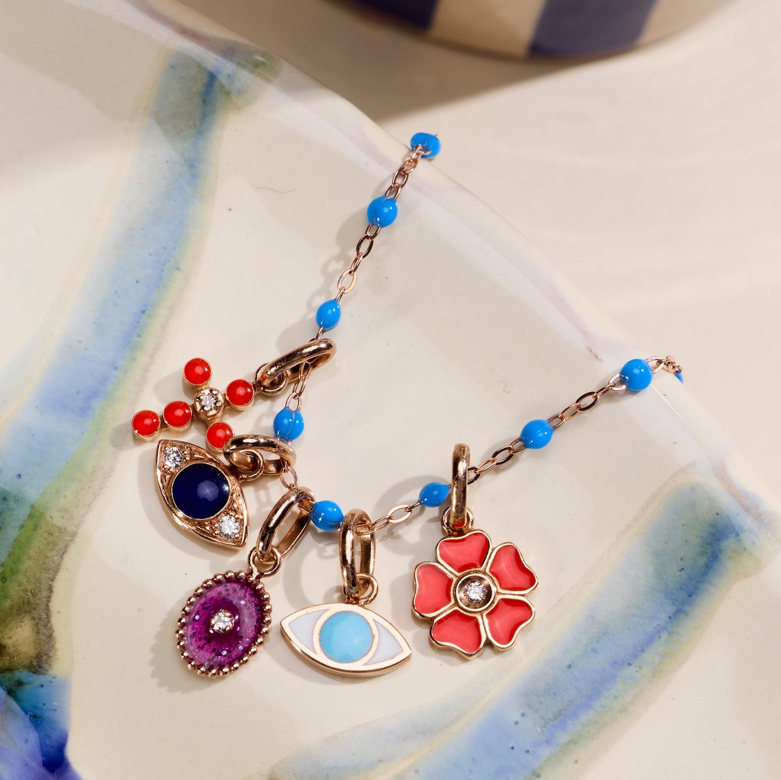 Photo de différents pendentifs Gigi Clozeau posés sur une assiette.